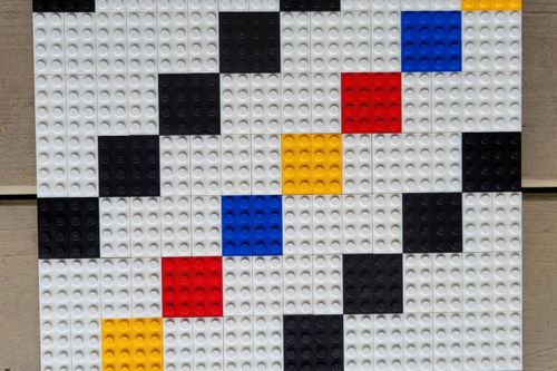 Diagonal small square pattern using primary colors, black, and white bricks
