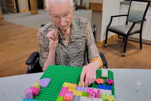 A senior using DUPLO® to create a design