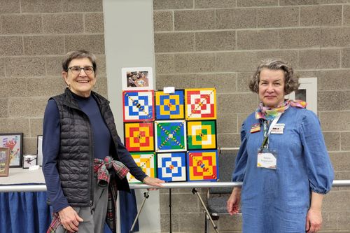 Natalia presenting brick pattern squares at a conference
