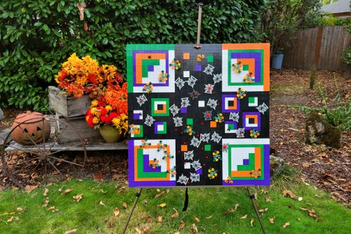 A presentation of a large square pattern outside using small LEGO® bricks
