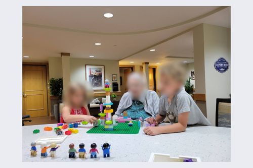 Blurred senior creating with bricks and spending time with their grandchildren 